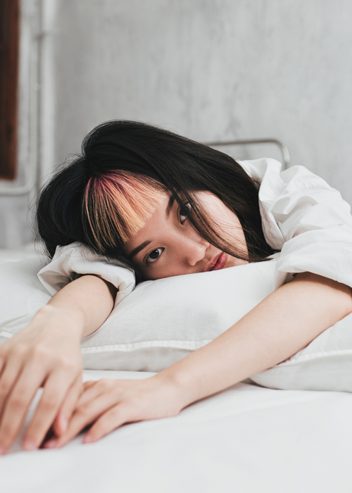 tired woman in bed 