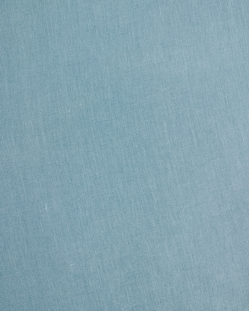 The Lagoon Heavy Linen Bed Cover by Bed Threads features light blue fabric with a fine woven texture and visible diagonal lines, offering a soft, smooth feel—ideal for luxury bedding or stylish bed covers.