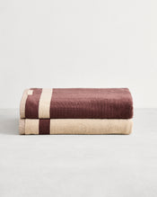 Stack of two cotton terry bath sheeets in reversible colours creme and cacao. - view