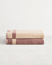 Stack of two cotton terry bath sheets in reversible colours lavender and creme. - view