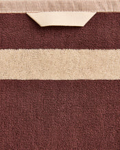 Close-up of a cotton terry towel in a cacao colourway with a creme border. - view