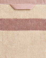 Close-up of a cotton terry towel in a creme colourway with a lavender border. - view