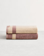 Stack of two cotton terry towels in reversible colours lavender and creme. - view