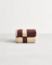 Stack of two cotton terry hand towels in reversible colours creme and cacao. - view