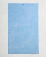 The Sky 100% Cotton Terry Bath Sheet by Bed Threads features a rectangular light blue design with a purple loop and beige tag—an ideal plush, quick-drying towel to elevate any bathroom. - view